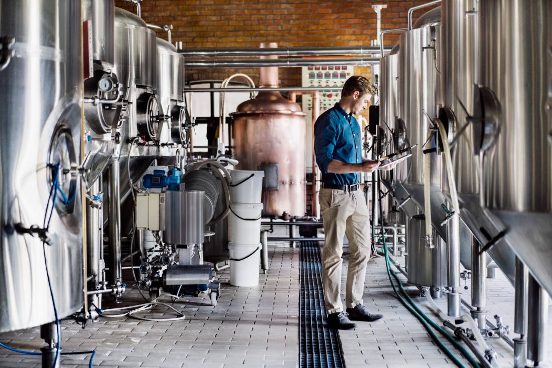 Brewer checking tanks in a craft brewery